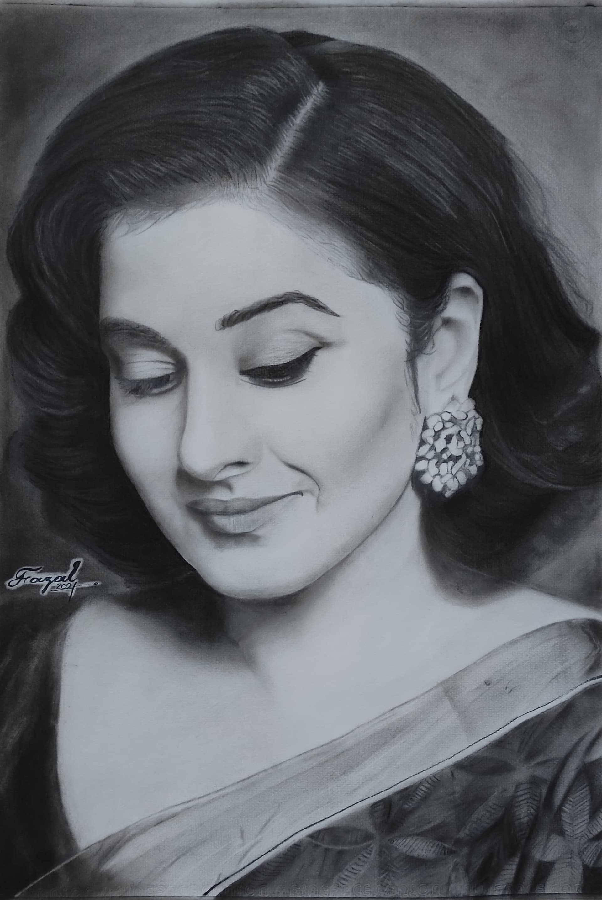 Charcoal portrait of Vidya Balan looking downward.