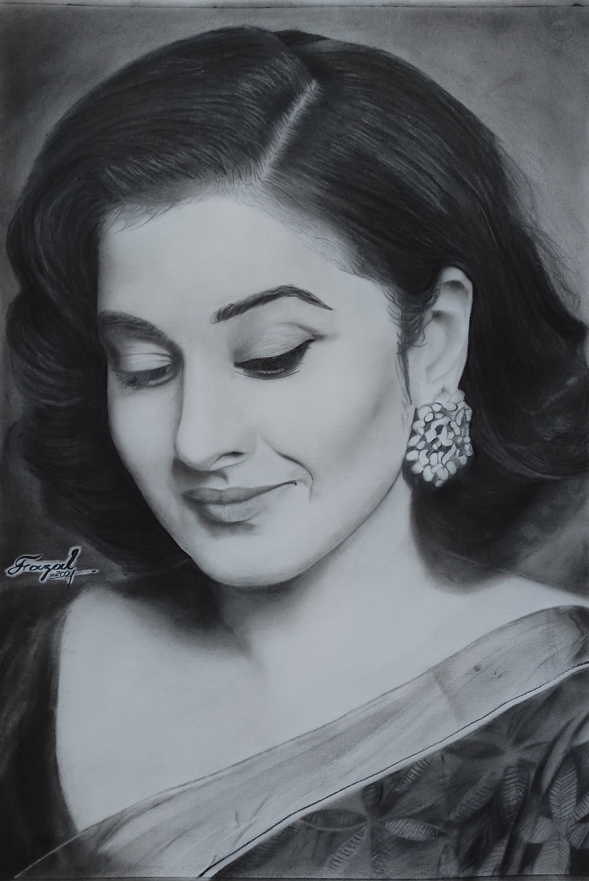 Charcoal portrait of Vidya Balan looking downward.